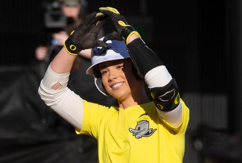 Oregon's Ariel Carlson flashes the O after hitting a home run against Portland State.