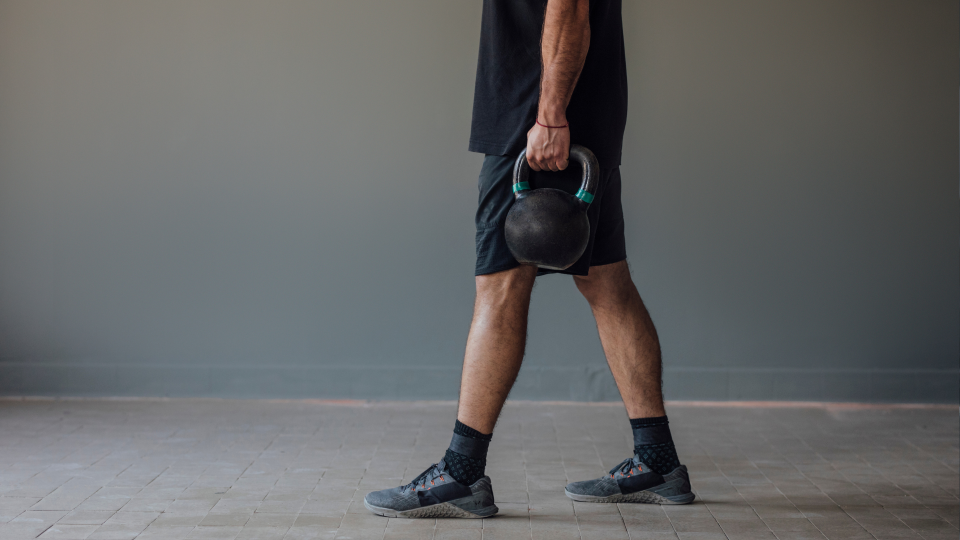 Man carrying kettlebell