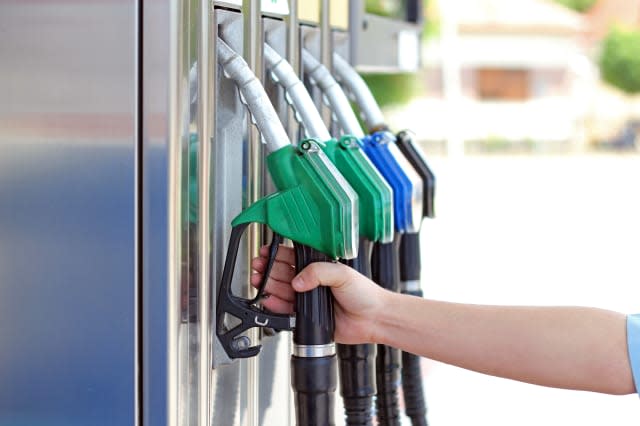 Close-up of a men's hand using a fuel nozzle at a gas station.Petrol station. Filling station. Petrol. Gasoline.