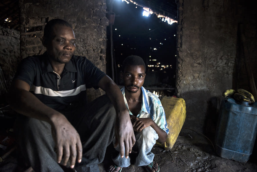 Akolio Bosumbuka at home with one of his sons. (Photo: Neil Brandvold/DNDi)