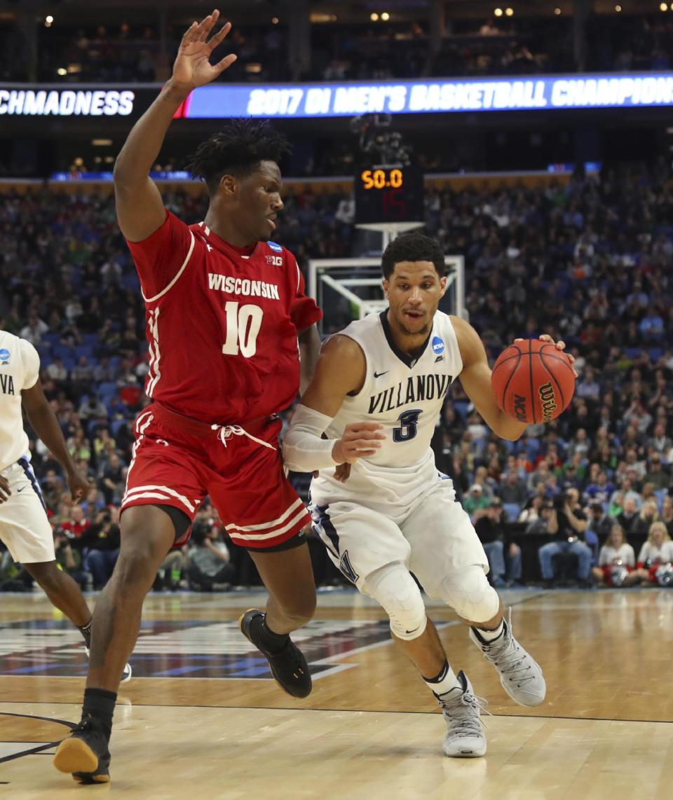 Villanova guard Josh Hart (3) drives to the basket against Wisconsin forward Nigel Hayes (10) during the second half of a second-round men's college basketball game in the NCAA Tournament, Saturday, March 18, 2017, in Buffalo, N.Y. Wisconsin won, 65-62. (AP Photo/Bill Wippert)