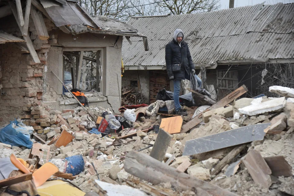People look at the ruins of houses destroyed by a Russian missile that hit a residential area in the village of Velika Vilshanytsia, near Lviv, Ukraine, March 9, 2023.  / Credit: Pavlo Palamarchuk/Anadolu Agency/Getty