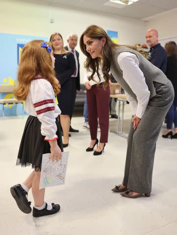<p>Chris Jackson/Getty </p> Kate Middleton speaks to 8-year-old Ukrainian refuge, Liza.