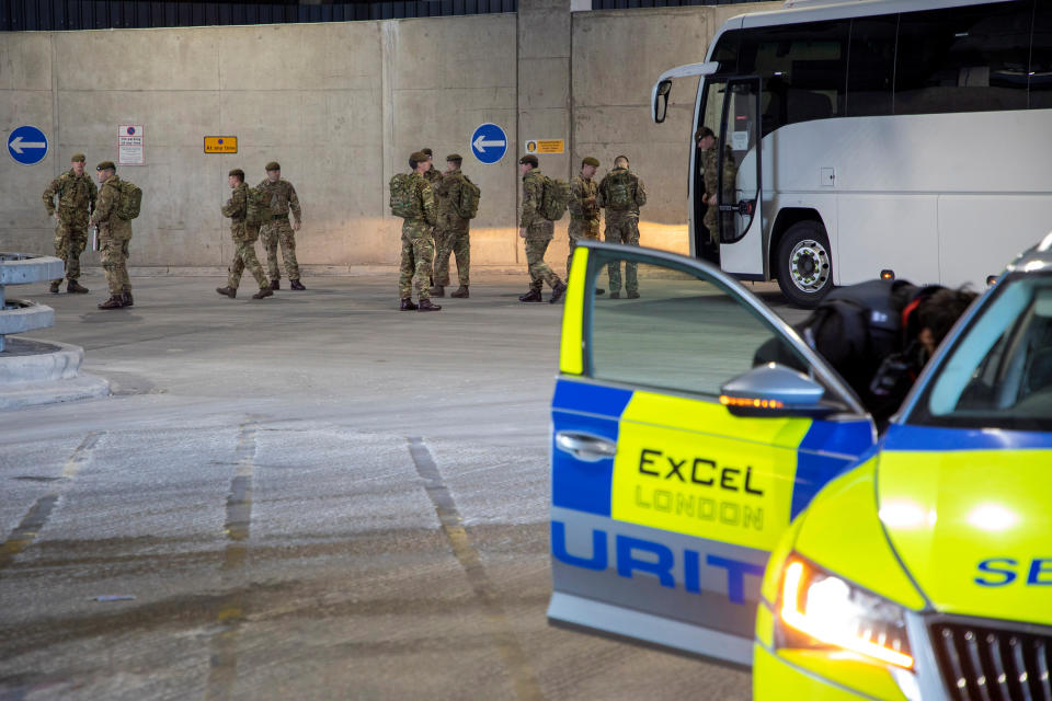 Soldiers from 1 Royal Anglian Regiment arrive at the ExCel centre to help build the new hospital.