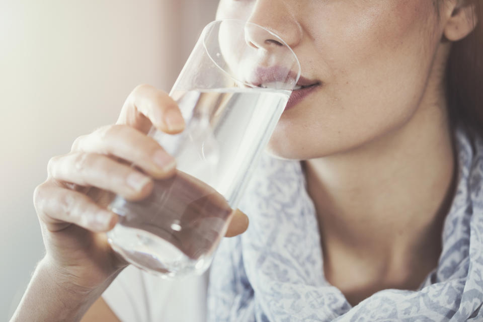 Woman drinks glass of water