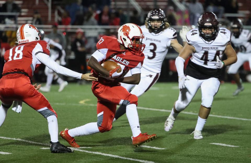 Smyrna's Tim Yancy is pursued by Appoquinimink's Jordan Linsmeier (3) and Brayden Earl in the second half of Smyrna's 48-7 win at Smyrna High School, Friday, November 5, 2021.