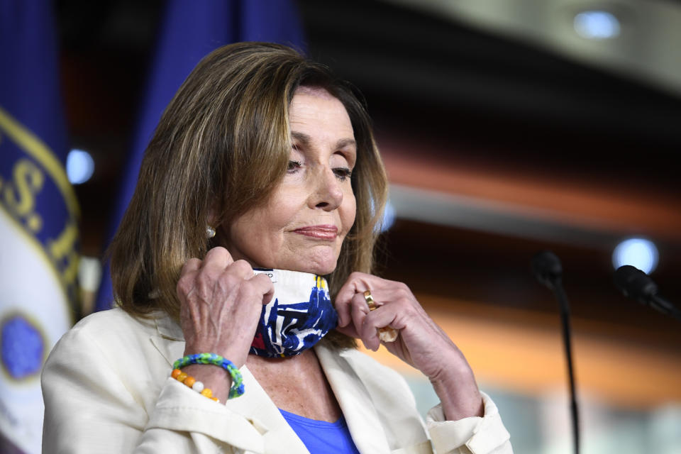 House Speaker Nancy Pelosi of Calif., pulls down her mask to speak at a news conference on Capitol Hill in Washington, Thursday, July 16, 2020. (AP Photo/Susan Walsh)