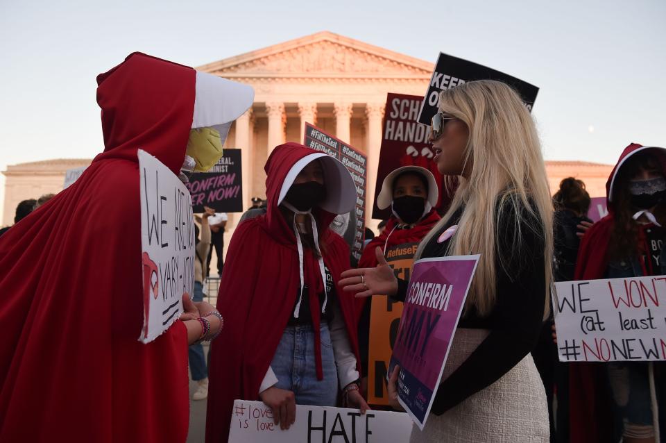 Opponents and supporters of Judge Amy Coney Barrett's nomination confront  each other outside the U.S. Supreme Court building on Monday.  (Photo: OLIVIER DOULIERY via Getty Images)