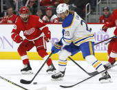 Buffalo Sabres center Cody Eakin (20) moves the puck against Detroit Red Wings center Sam Gagner (89) during the second period of an NHL hockey game Saturday, Nov. 27, 2021, in Detroit. (AP Photo/Duane Burleson)