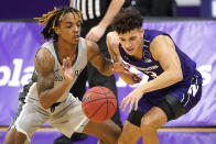 Chicago State guard Rajeir Jones, left, and Northwestern guard Ty Berry battle for a loose ball during the first half of an NCAA college basketball game in Evanston, Ill., Saturday, Dec. 5, 2020. (AP Photo/Nam Y. Huh)