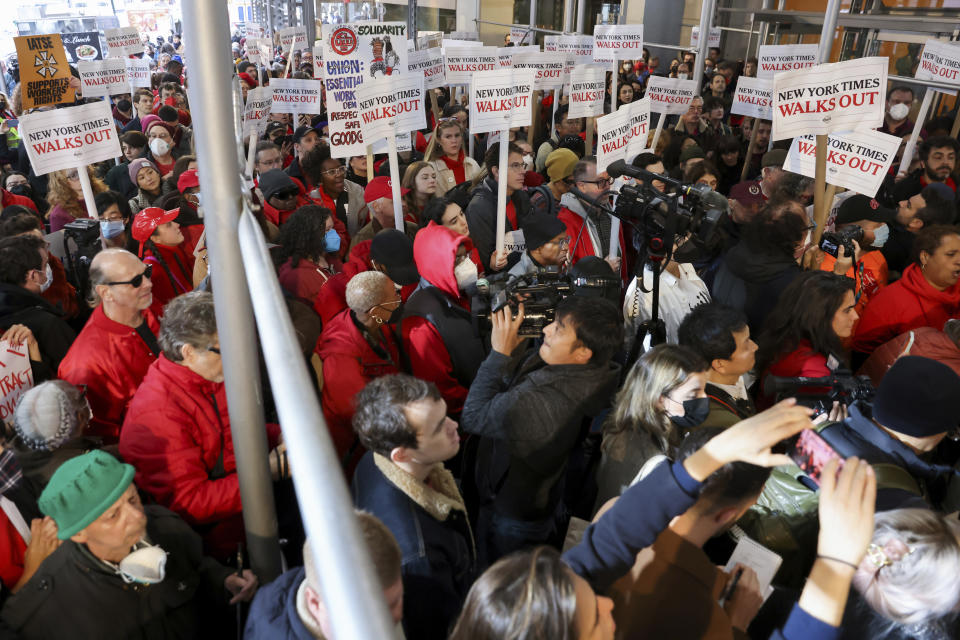 Hundreds of New York Times journalists and other staff protest outside the Times' office after walking off the job for 24 hours, frustrated by contract negotiations that have dragged on for months in the newspaper's biggest labor dispute in more than 40 years, Thursday, Dec. 8, 2022, in New York. (AP Photo/Julia Nikhinson)