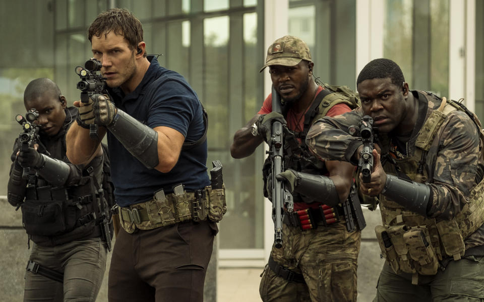 This image released by Amazon shows Chris Pratt, from second left, Edwin Hodge and Sam Richardson in a scene from "The Tomorrow War." (Frank Masi/Amazon via AP)