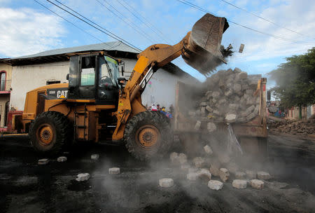 A tractor destroys a barricade after riot police clashes with anti-government protesters in the indigenous community of Monimbo in Masaya, Nicaragua July 17, 2018. REUTERS/Oswaldo Rivas