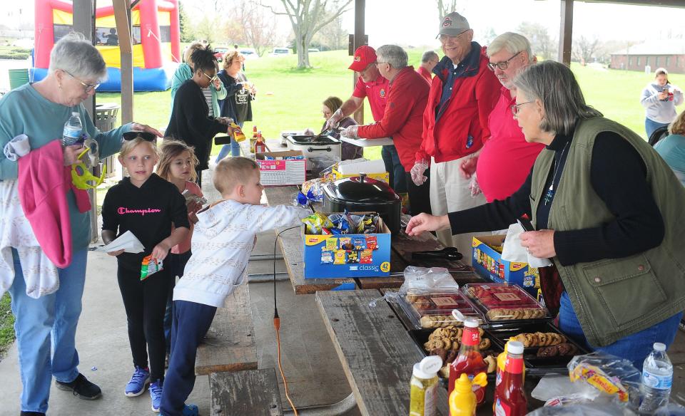 Visitors line up Monday, April 8, 2024, for free food donated by the Alliance Lions Club during The Total Solar Eclipse Watch Party at Butler Rodman Park in Alliance.