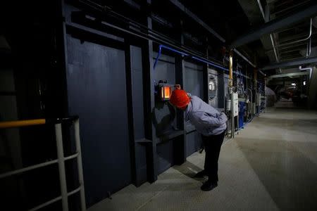 An employee works inside a newly launched waste-to-energy plant by Suzhou Wujiang Everbright Environmental Energy Ltd in Wujiang of Suzhou, Jiangsu province, China, November 8, 2016. REUTERS/Aly Song