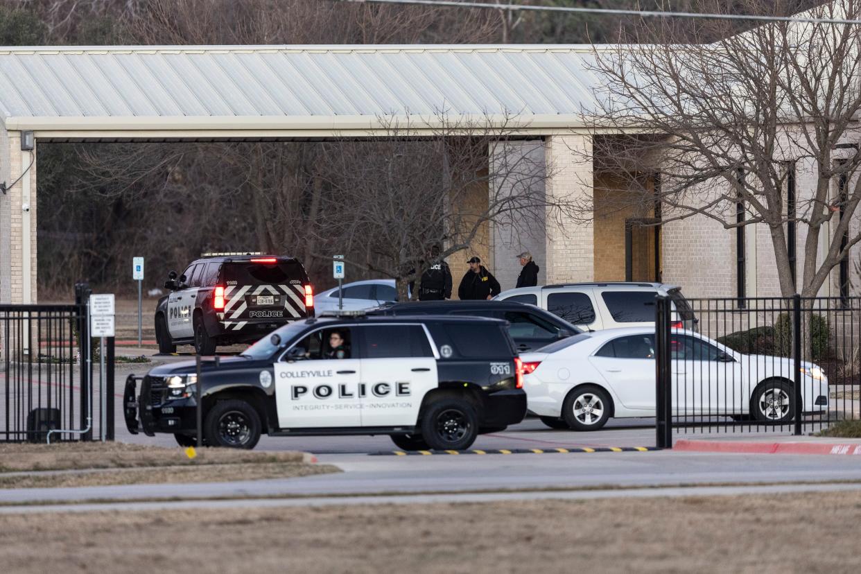 Police stand in front of the Congregation Beth Israel synagogue, Sunday, Jan. 16, 2022, in Colleyville, Texas.