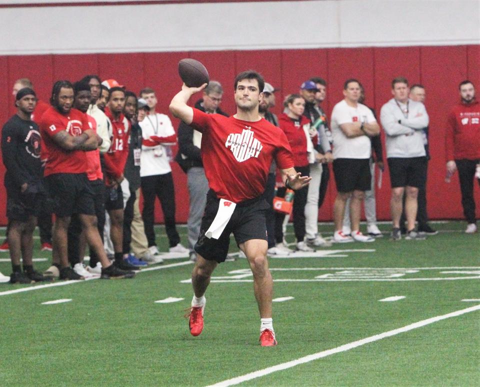 Wisconsin's Tanner Mordecai throws a pass as teammates and NFL scouts watch during the Badgers pro day on Friday March 15, 2024 at the McClain Center in Madison, Wisconsin.