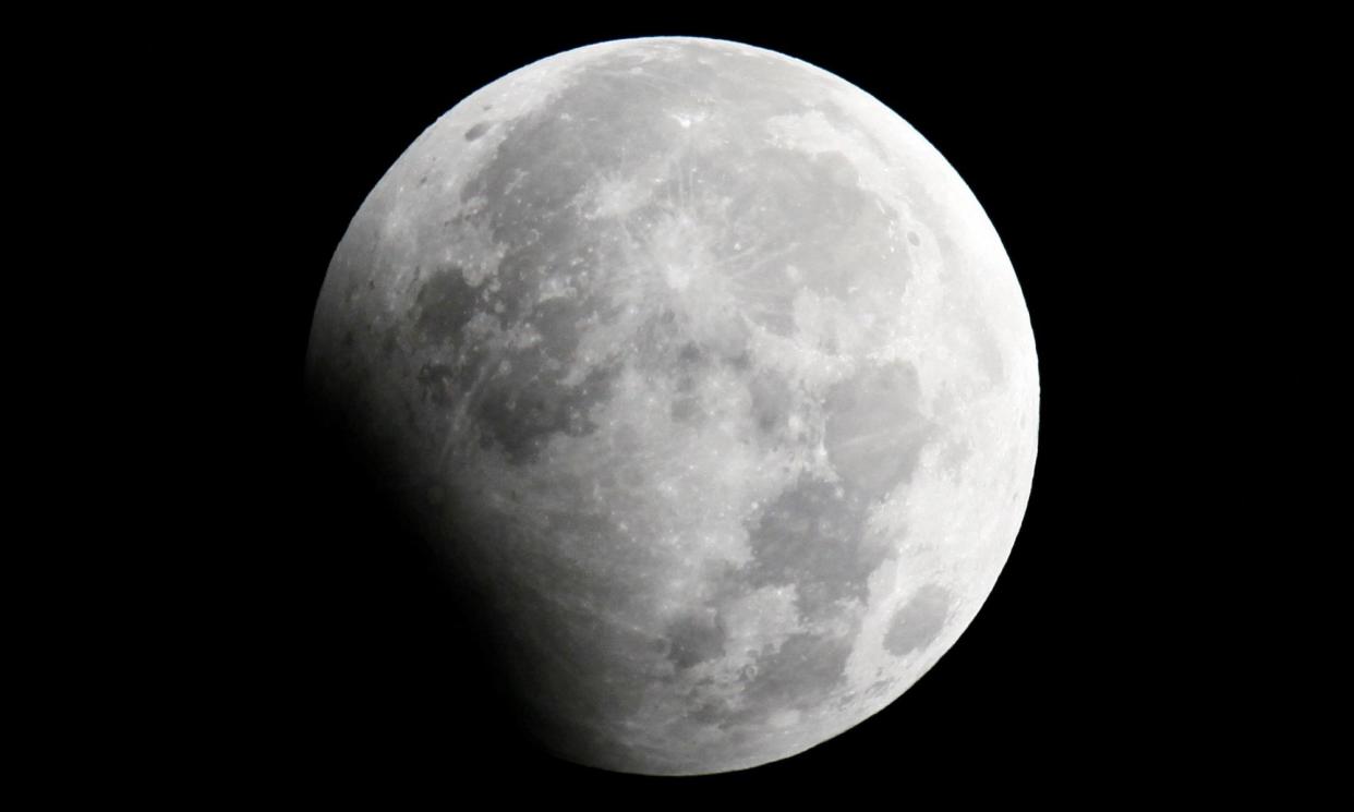 <span>A partial lunar eclipse seen from Shanghai in 2010. This time, the eclipse will be visible across Europe, Africa, Greenland and North and South America.</span><span>Photograph: Aly Song/Reuters</span>