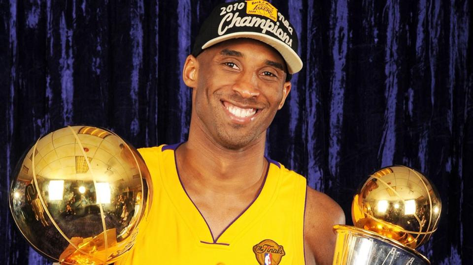 Kobe Bryant holds the Larry O'Brien Trophy and the Bill Russell MVP Trophy in 2010. Photo: Getty Images