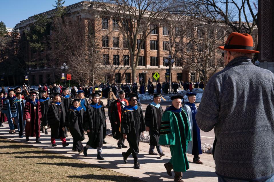 A procession makes its way around campus before a ceremony for the inauguration of Santa J. Ono as University of Michigan's 15th president near Hill Auditorium in Ann Arbor on Tuesday, March 7, 2023.