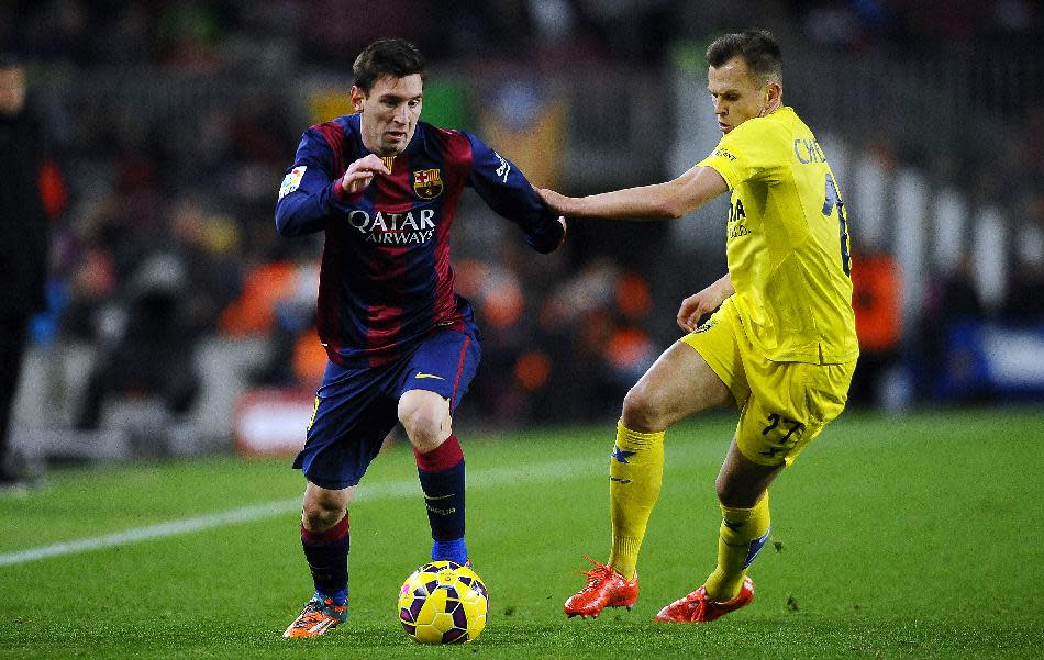 FC Barcelona&#39;s Lionel Messi, from Argentina, left, duels for the ball against Villarreal&#39;s Denis Cheryshev during a Spanish La Liga soccer match at the Camp Nou stadium in Barcelona, Spain, Sunday, Feb. 1, 2015. (AP Photo/Manu Fernandez)