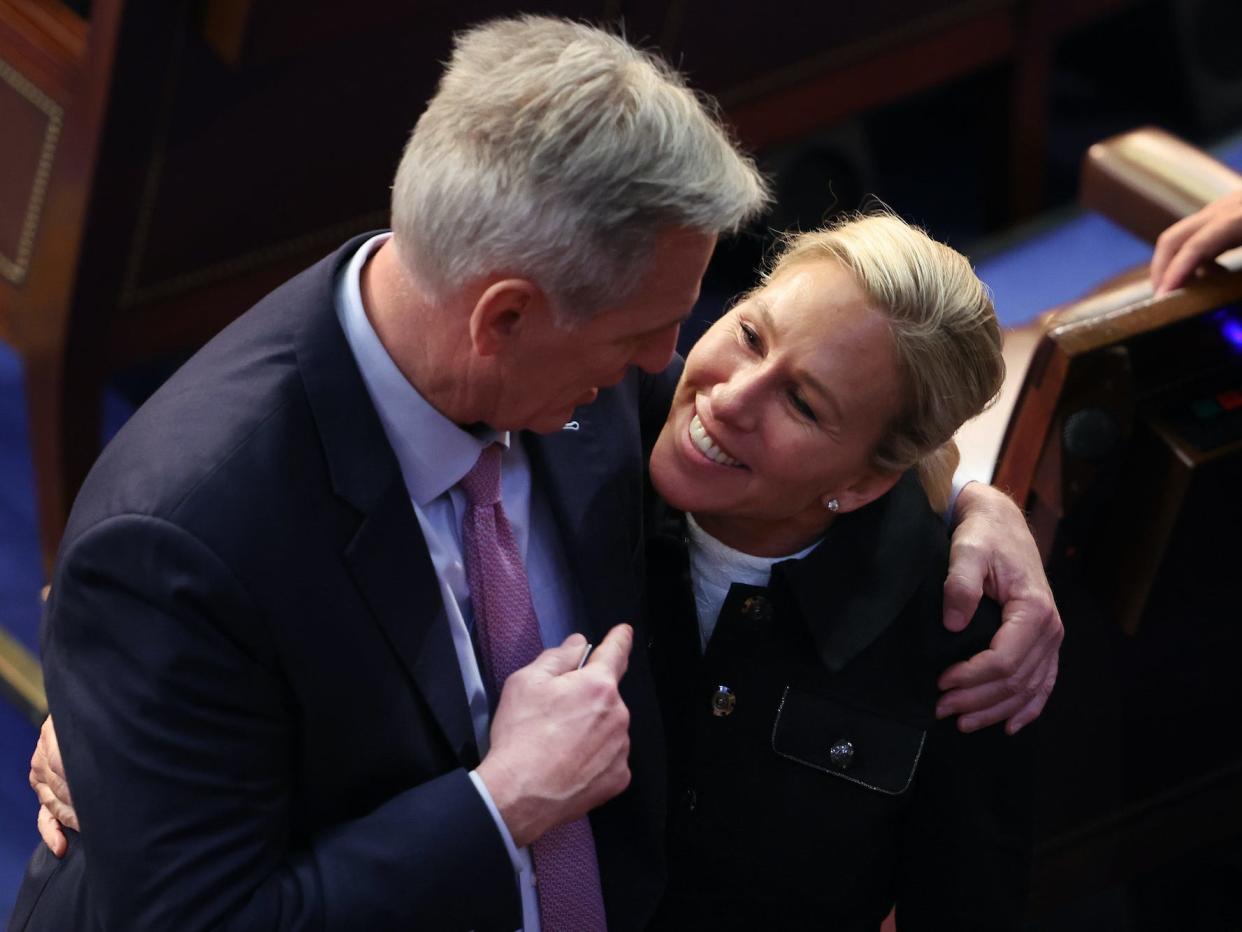US House Republican leader Kevin McCarthy embraces Rep.-elect Majorie Taylor Greene (R-GA) in the House Chamber during the fourth day of elections for Speaker of the House at the US Capitol Building on January 06, 2023 in Washington, DC.