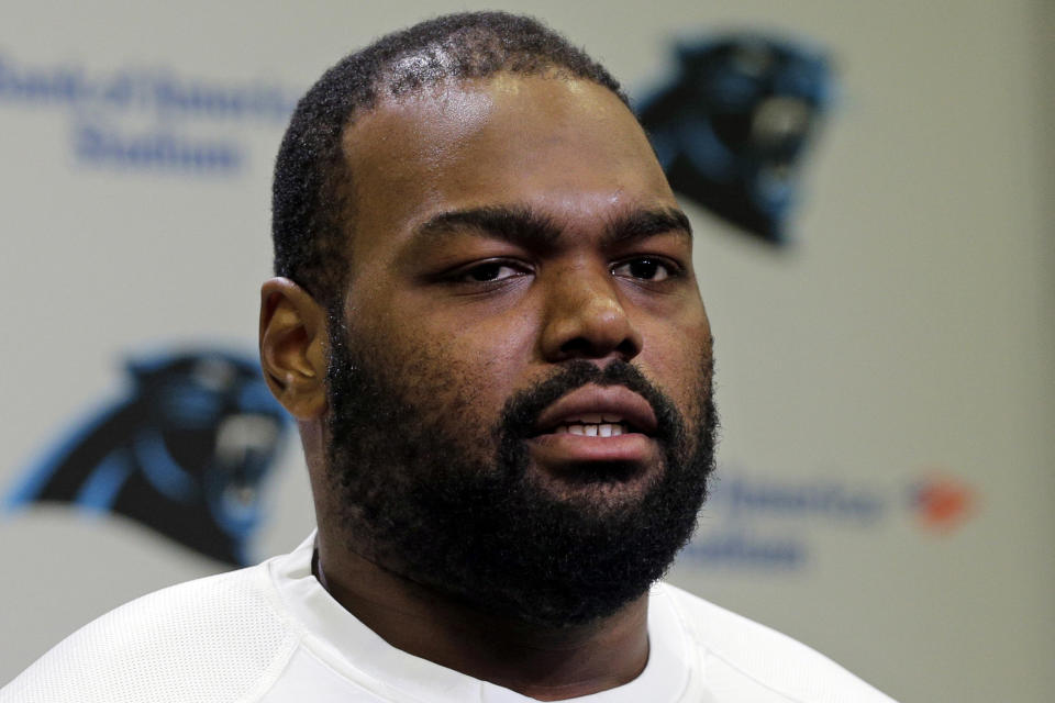 FILE - Carolina Panthers' Michael Oher speaks to the media during the first day of their NFL football offseason conditioning program in Charlotte, N.C., April 20, 2015. Oher, the former NFL tackle known for the movie “The Blind Side,” filed a petition Monday, Aug. 14, 2023, in a Tennessee probate court accusing Sean and Leigh Anne Tuohy of lying to him by having him sign papers making them his conservators rather than his adoptive parents nearly two decades ago.(AP Photo/Chuck Burton, File)