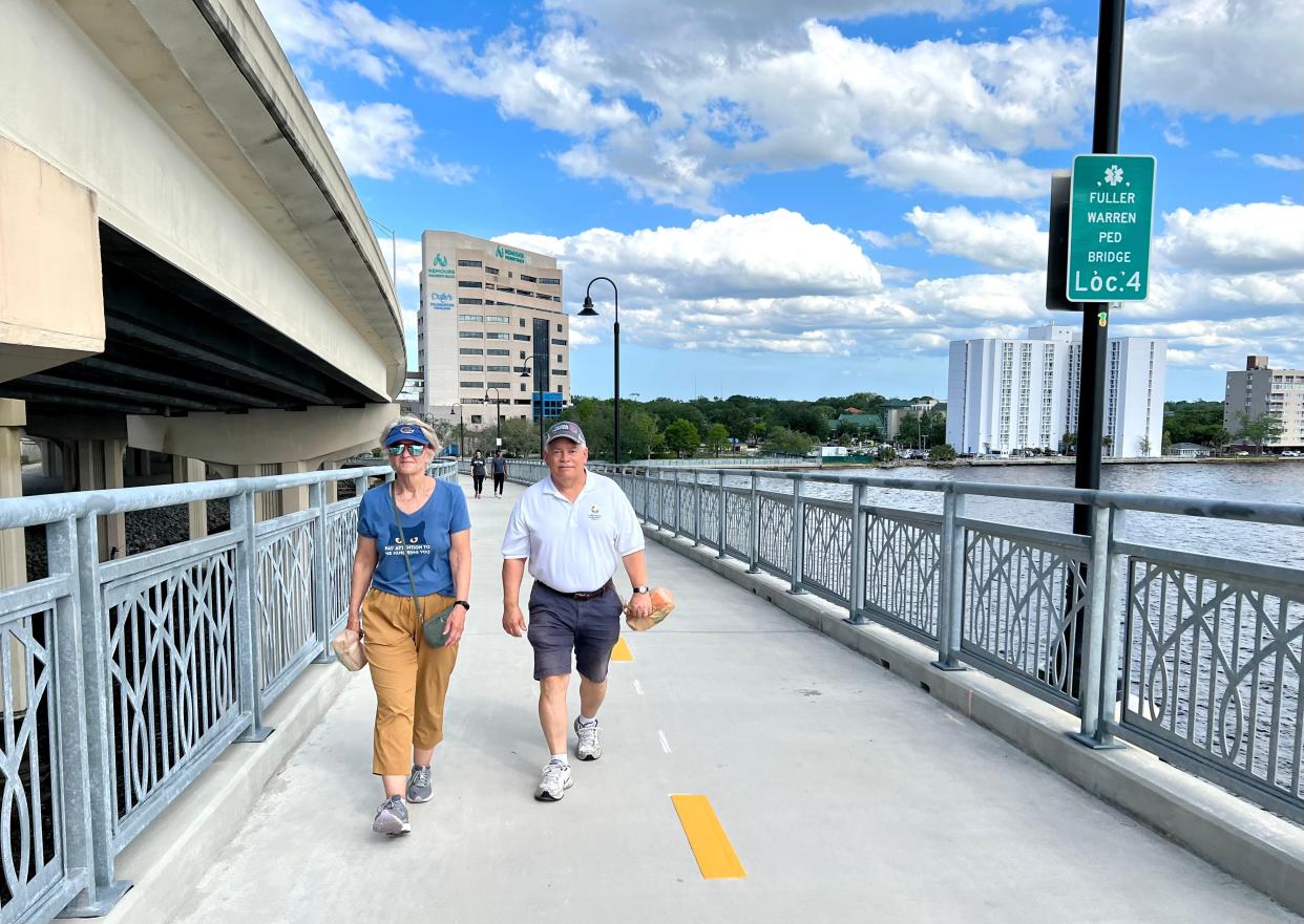 Diane and Stan Pilinski walk the Fuller Warren shared-use path, carrying bags to pick up trash. Stan Pilinski regularly walks the downtown bridges and picks up trash.