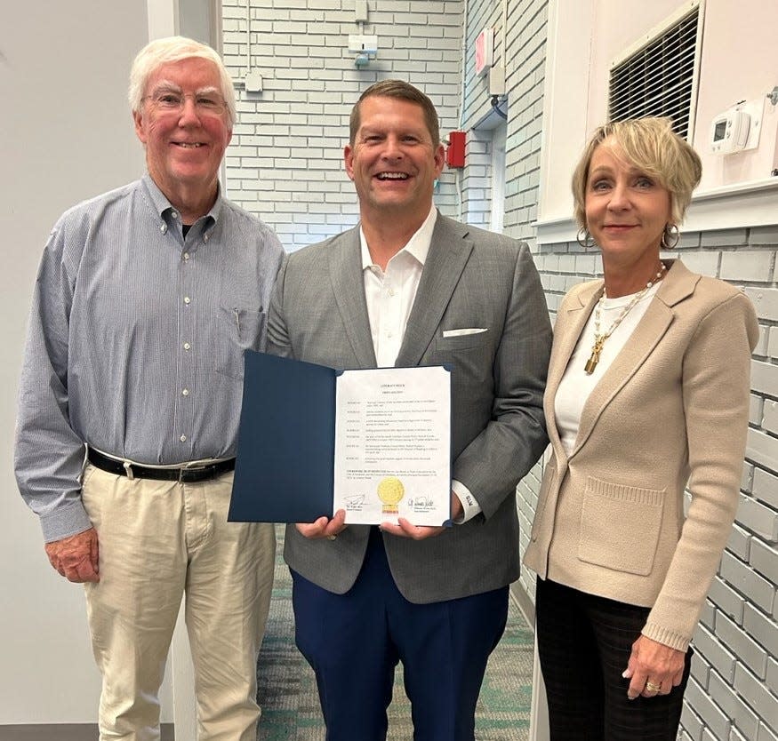 Chatham Education Alliance Chair, George Woods (center) poses with CEA Literacy Week Steering Committee members Rick Roney (left) and Terri O'Neil (right) after having received the SCCPSS Literacy Week proclamation plaque on Nov. 1, 2023 at the Whitney Complex.