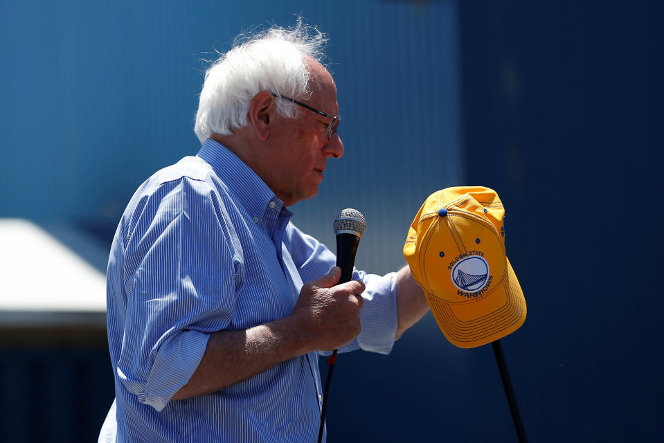 Bernie Sanders holds a Golden State Warriors hat during a campaign rally in Santa Cruz, Calif., May 31, 2016. (Stephen Lam/Reuters)