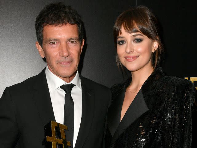 <p>Frazer Harrison/Getty</p> Antonio Banderas, winner of the Hollywood Actor Award, and Dakota Johnson pose in the press room during the 23rd Annual Hollywood Film Awards