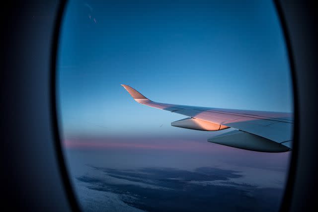 <p>Getty</p> A stock image of an airplane window.