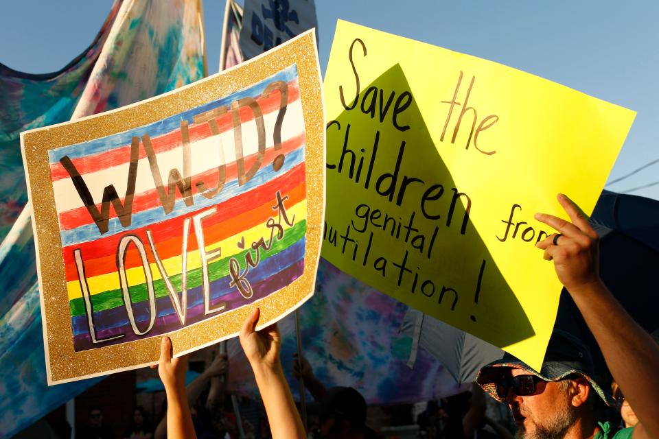 Protesters against the Athens Pride and Queer Collective's Athens Pride Week Kids and Youth Night Drag Story Hour are meet with counter-protesters outside of Hendershot's Coffee in Athens, Ga., on Wednesday, Sept. 14, 2022.