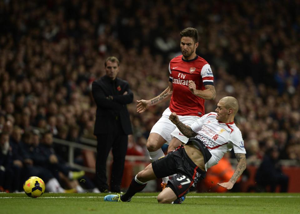 Arsenal's Giroud challenges Liverpool's Skrtel during their English Premier League soccer match at the Emirates stadium in London