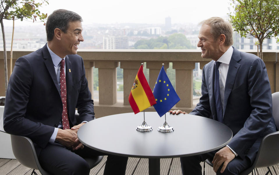 Spanish Prime Minister Pedro Sanchez, left, speaks with European Council President Donald Tusk during a meeting on the sidelines of an EU summit in Brussels, Sunday, June 30, 2019. (AP Photo/Virginia Mayo, Pool)