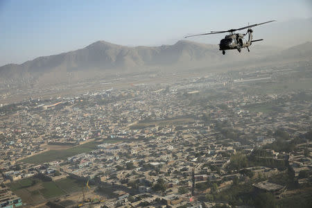 A Blackhawk helicopter flies over Kabul October 3, 2014. REUTERS/Dan Kitwood