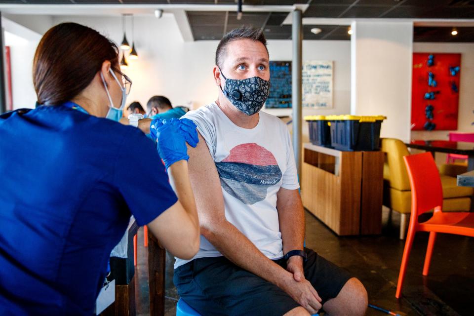 Jay Young receives a COVID-19 booster vaccine dose during a Riverside County vaccination clinic inside Roly China Fusion in Palm Springs, Calif., on August 26, 2021. No appointments were necessary at the mobile clinic. 