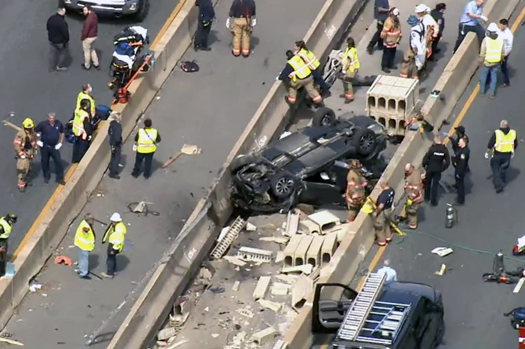 Emergency personnel work the scene of a crash on I-695 in Baltimore County that left multiple people dead Wednesday. (WBAL)