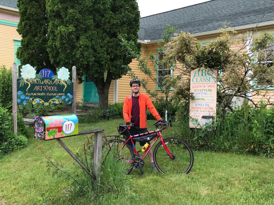 Jonathan Blakeslee in front of Sanctuary Arts on a Seacoast Area Bicycle Riders sustainability ride
