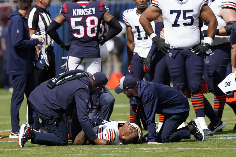 Chicago Bears running back David Montgomery is helped by medical personnel after being injured during the first half of an NFL football game against the Houston Texans Sunday, Sept. 25, 2022, in Chicago. (AP Photo/Charles Rex Arbogast)