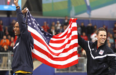 Gold medallist USA's Shani Davis, left, and Bronze medallist USA's Chad Hedrick, right, walk to the podium of the flower ceremony