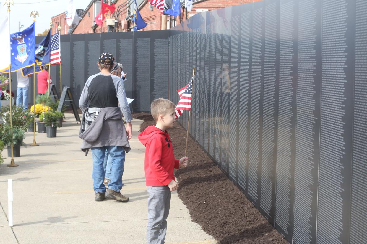 Griffin Campbell looks over the Vietnam Wall on display through Sunday afternoon at the New Philadelphia VFW.