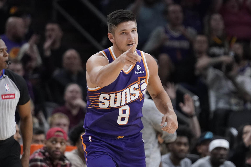 Phoenix Suns guard Grayson Allen (8) gestures after hitting a 3-pointe during the first quarter of an NBA basketball game in Phoenix, Thursday, March. 7, 2024. (AP Photo/Darryl Webb)