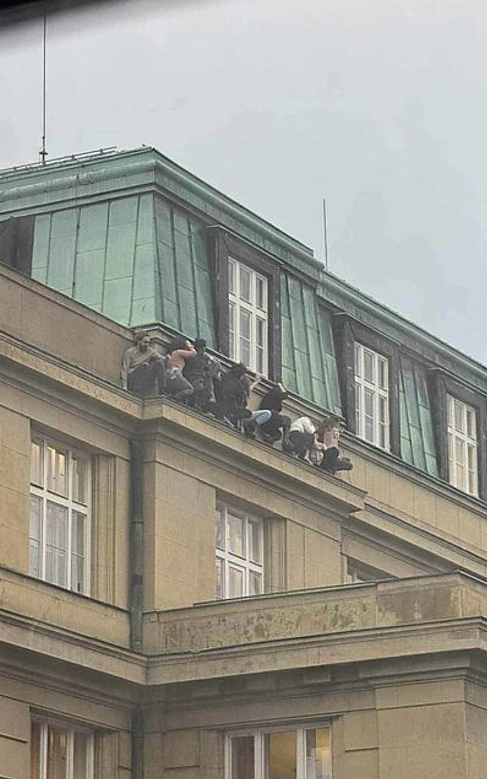 Students hiding on the ledge of a building during the shooting