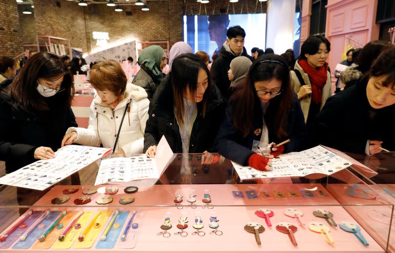 Fans of K-pop idol boy band BTS shop at a pop-up store selling BTS goods in Seoul