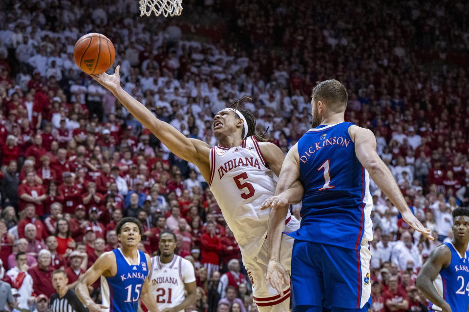 Indiana forward Malik Reneau (5) attempts to score while being defended by Kansas center Hunter Dickinson (1) during the second half of an NCAA college basketball game, Saturday, Dec. 16, 2023, in Bloomington, Ind. (AP Photo/Doug McSchooler)