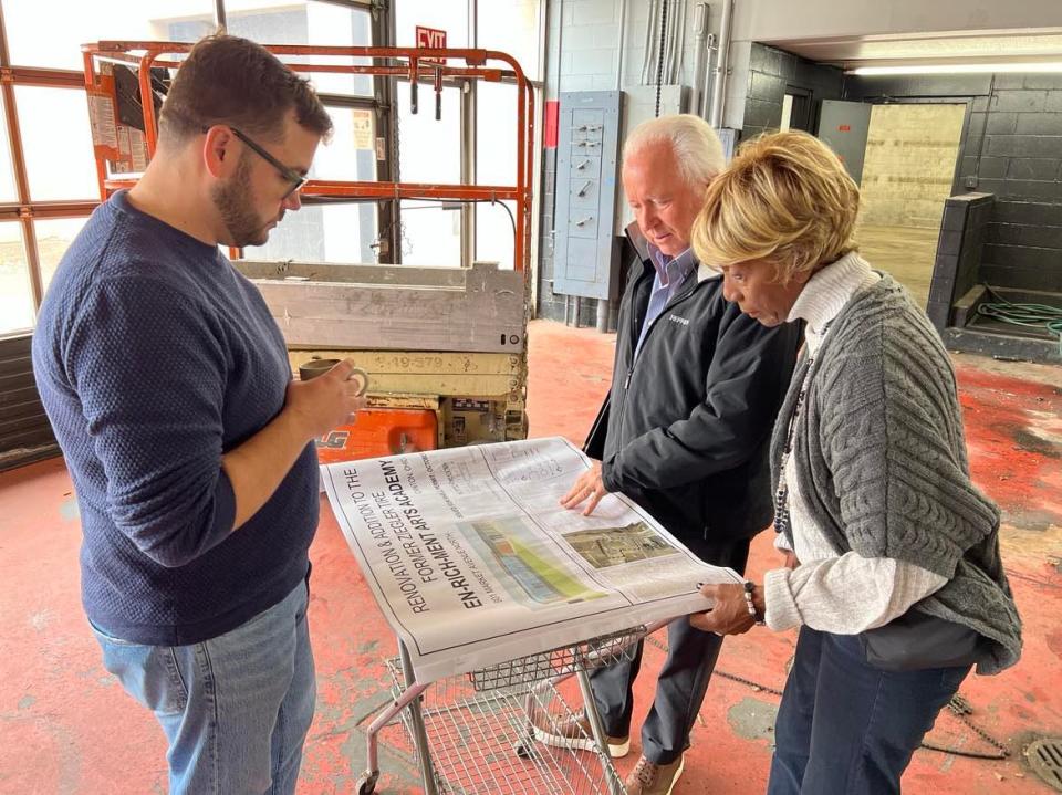 Ted Swaldo points at blueprint plans for renovations to the former Ziegler Tire building in downtown Canton. The building will become the permanent home of EN-RICH-MENT Fine Arts Academy.
