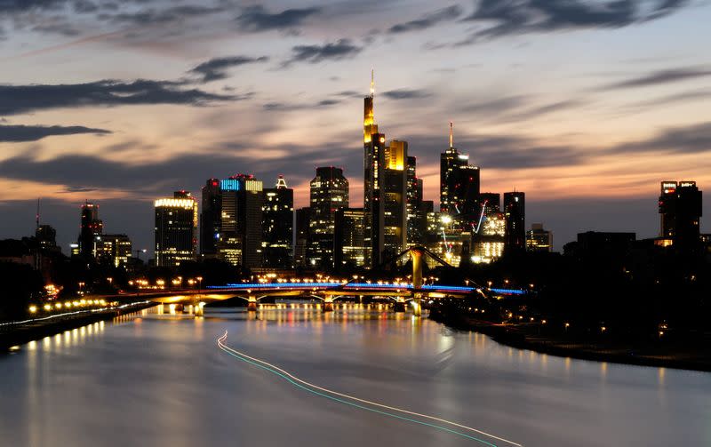 FILE PHOTO: The sun sets behind the skyline of Frankfurt