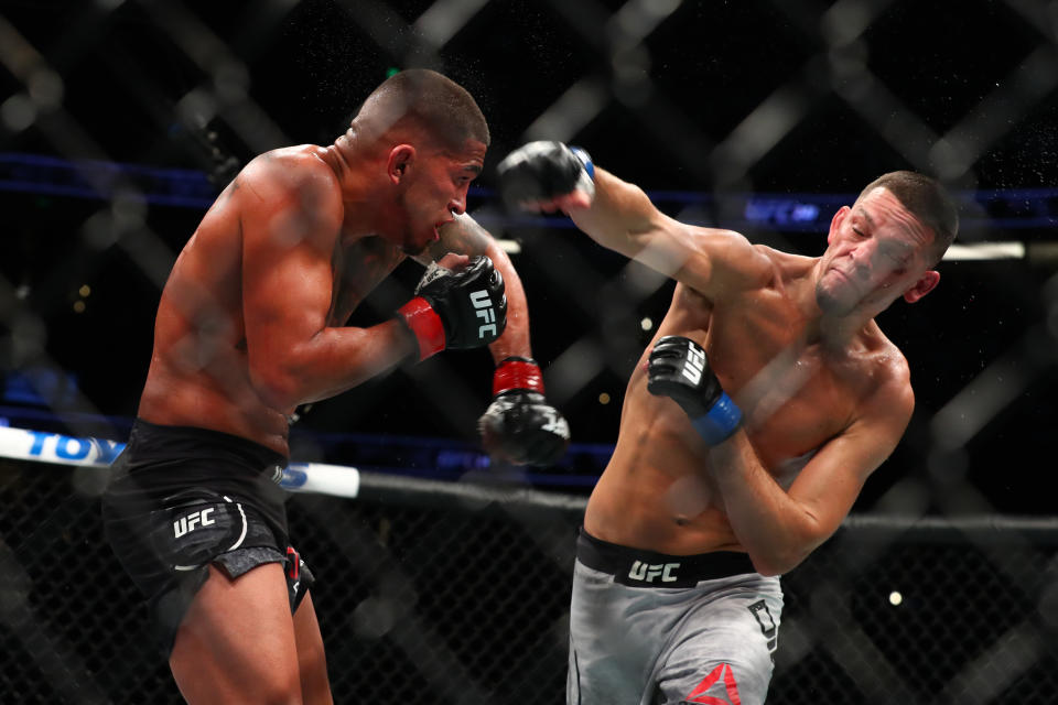 ANAHEIM, CALIFORNIA - AUGUST 17: Nate Diaz throws a punch at Anthony Pettis in the second round during their Welterweight Bout at UFC 241 at Honda Center on August 17, 2019 in Anaheim, California. (Photo by Joe Scarnici/Getty Images)