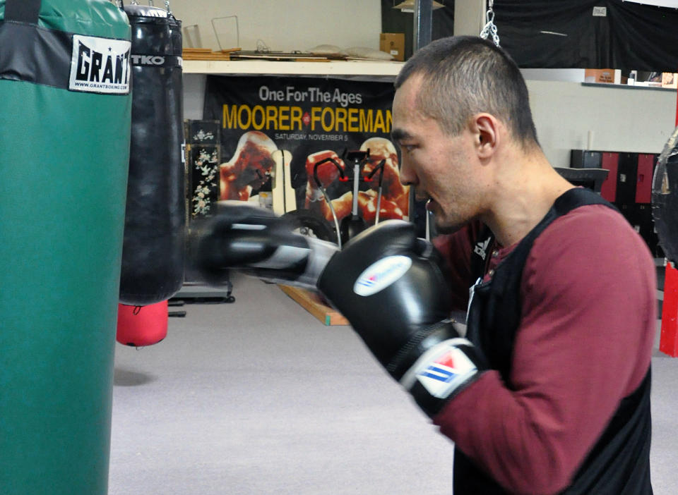 In this photo taken April 5, 2014, WBA and IBA light heavyweight boxing champion Beibut Shumenov, of Kazakhstan, hits a heavy bag in Las Vegas. Shumenov and IBF light heavyweight champion Bernard King will fight at the DC Armory on Saturday, April 19. (AP Photo/Joe Coomber)